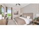 Guest bedroom with patterned wallpaper and neutral bedding at 10160 Silent Night Ln, Sarasota, FL 34241