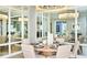 Elegant dining room with mirrored wall and modern chandelier at 10160 Silent Night Ln, Sarasota, FL 34241