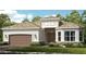 Attractive one-story home with brown roof and garage at 10160 Silent Night Ln, Sarasota, FL 34241