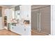 Modern kitchen with white cabinets, stainless steel appliances, and farmhouse sink at 10160 Silent Night Ln, Sarasota, FL 34241