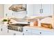 White kitchen cabinets, stainless steel range, and quartz countertops at 10160 Silent Night Ln, Sarasota, FL 34241