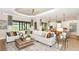 Bright and airy living room with comfortable seating and open floor plan at 10160 Silent Night Ln, Sarasota, FL 34241
