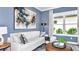 Bright home office with blue shiplap walls and large windows at 10160 Silent Night Ln, Sarasota, FL 34241