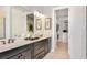 Elegant bathroom with double vanity, large mirror, and walk-in closet at 10224 Silent Night Ln, Sarasota, FL 34241