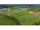 Community overview featuring sports fields and a lake at 10446 Morning Mist Ln, Sarasota, FL 34241