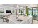 Kitchen island with white cabinets, quartz countertops, and a large sink at 10446 Morning Mist Ln, Sarasota, FL 34241