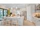 Modern kitchen with white cabinets, quartz countertops, and stainless steel appliances at 10446 Morning Mist Ln, Sarasota, FL 34241