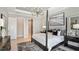 Main bedroom with a four-poster bed and a large framed print above the bed at 10446 Morning Mist Ln, Sarasota, FL 34241