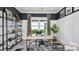 Modern home office with built-in shelving and large window at 10446 Morning Mist Ln, Sarasota, FL 34241