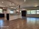 Open kitchen with island, exposed brick, and dark cabinets at 123 Chauncey Ave, Bradenton, FL 34208