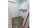 Laundry room with white cabinets and grey tile floor at 123 Chauncey Ave, Bradenton, FL 34208