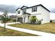 Two-story house with gray siding, dark brown garage door, and landscaping at 12626 Bergstrom Bay Dr, Riverview, FL 33579