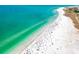 Aerial view of a beach with many people enjoying the sun and water at 1275 Siesta Bayside Dr # 1275, Sarasota, FL 34242