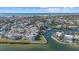 Aerial view of waterfront community, showcasing homes, landscaping, and beach access at 1275 Siesta Bayside Dr # 1275, Sarasota, FL 34242