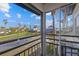 Balcony view overlooking a tranquil pond and lush landscaping at 1275 Siesta Bayside Dr # 1275, Sarasota, FL 34242