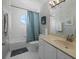 Bright bathroom with white tiled walls, tub shower combo, and updated vanity at 1275 Siesta Bayside Dr # 1275, Sarasota, FL 34242