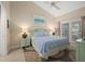 Spacious bedroom with king-size bed, access to balcony, and coastal decor at 1275 Siesta Bayside Dr # 1275, Sarasota, FL 34242