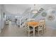 Charming dining area with table and chairs, adjacent to staircase and living room at 1275 Siesta Bayside Dr # 1275, Sarasota, FL 34242