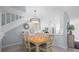 Bright dining area with light-colored table and chairs, kitchen view at 1275 Siesta Bayside Dr # 1275, Sarasota, FL 34242