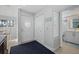 Bright entryway with coat closet and view into the bathroom at 1275 Siesta Bayside Dr # 1275, Sarasota, FL 34242