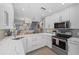 Modern kitchen with white cabinets and quartz countertops at 1275 Siesta Bayside Dr # 1275, Sarasota, FL 34242