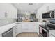 Modern kitchen with white cabinets and quartz countertops at 1275 Siesta Bayside Dr # 1275, Sarasota, FL 34242