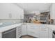 Modern kitchen with white cabinets and quartz countertops at 1275 Siesta Bayside Dr # 1275, Sarasota, FL 34242