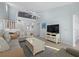 Relaxing living room with sectional sofa, coffee table, and large TV at 1275 Siesta Bayside Dr # 1275, Sarasota, FL 34242