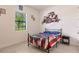 Bedroom with a full-size bed, nightstand, and Jeep-themed decor at 12811 Wheatgrass Ct, Parrish, FL 34219