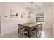 Bright dining room features a large wood table with seating for six at 12811 Wheatgrass Ct, Parrish, FL 34219