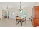 Bright dining room with an oval table and wooden hutch at 1419 Quail Lake Dr, Venice, FL 34293