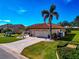 Landscaped front yard with driveway and tropical plants at 1419 Quail Lake Dr, Venice, FL 34293