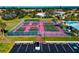 Aerial view showing tennis and pickleball courts with ample parking nearby at 1419 Quail Lake Dr, Venice, FL 34293