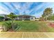 Landscaped backyard with lush grass and a view of the canal at 17413 Pheasant Cir, Port Charlotte, FL 33948