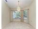 Bright dining room with large windows and chandelier at 17413 Pheasant Cir, Port Charlotte, FL 33948