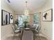 Elegant dining room with a table for six and large windows at 17413 Pheasant Cir, Port Charlotte, FL 33948
