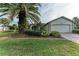 Single-story home with palm trees and landscaped lawn at 17413 Pheasant Cir, Port Charlotte, FL 33948