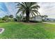 Single story home with lush landscaping and palm trees at 17413 Pheasant Cir, Port Charlotte, FL 33948