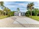 Gray exterior shed with a gravel driveway at 17413 Pheasant Cir, Port Charlotte, FL 33948
