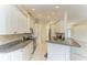 Kitchen with granite countertops and white cabinets at 17413 Pheasant Cir, Port Charlotte, FL 33948