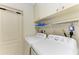 Bright laundry room with washer, dryer, and ample storage at 17413 Pheasant Cir, Port Charlotte, FL 33948