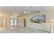 Living room with decorative wall mural and access to entryway at 17413 Pheasant Cir, Port Charlotte, FL 33948