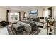 Main bedroom with a king-size bed and access to backyard at 17413 Pheasant Cir, Port Charlotte, FL 33948