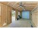 Workshop with roll-up door and ceiling fan at 17413 Pheasant Cir, Port Charlotte, FL 33948