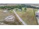 Aerial view showing home, driveway, and surrounding land at 19990 E State Road 64, Bradenton, FL 34212