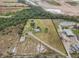 Aerial view showcasing home, lot, pond, and outbuildings at 19990 E State Road 64, Bradenton, FL 34212