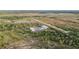 Aerial view of property with multiple buildings and vehicles at 19990 E State Road 64, Bradenton, FL 34212