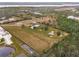 Aerial view of property showing home, expansive land, and pond at 19990 E State Road 64, Bradenton, FL 34212