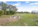 Large backyard with fire pit and shed at 19990 E State Road 64, Bradenton, FL 34212