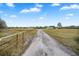 Long driveway leading to a single-wide mobile home at 19990 E State Road 64, Bradenton, FL 34212